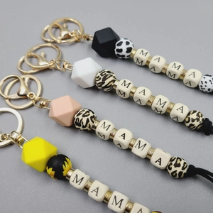 Detail of MAMA letter beads and silicone geometric beads on stylish handmade keychains