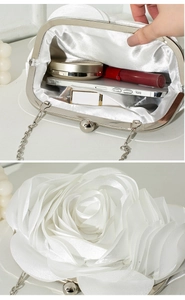 Detail view of white satin evening clutch with 3D rose and its spacious interior storage