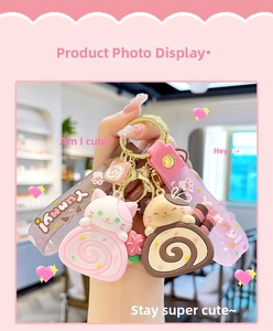 Detail of cute cat swiss roll keychains in pink and brown with silicone wrist straps