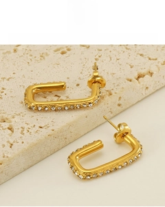 Detail of 18K gold plated U-shaped titanium earrings with cubic zirconia and 18K plating