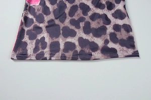 Close-up of leopard print dress hem featuring purple patterns and double-needle stitching