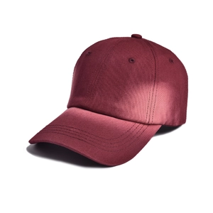 Detail view of burgundy baseball cap showing premium cotton fabric and reinforced stitching