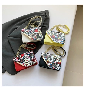 Detail view of four graffiti chain square bags in white, yellow, red and black leather