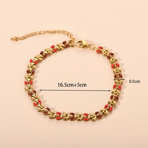 Detail view of 18K gold leaf bracelet with red enamel and adjustable lobster clasp closure