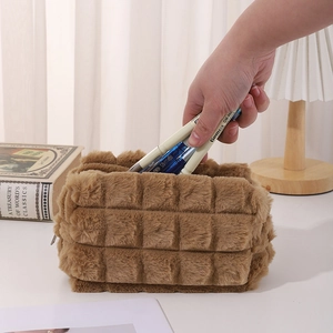 Detail of a plush brown quilted pencil case showing large capacity and zipper closure