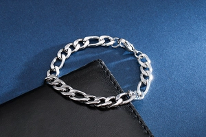 Detail of silver stainless steel NK chain bracelet on black leather with lobster clasp