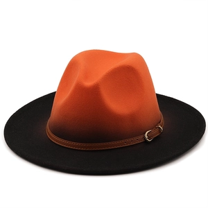 Close-up of dual-tone orange and black gradient fedora with brown leather belt