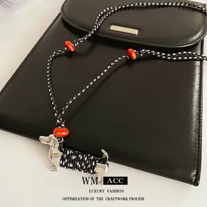 Dachshund dog ceramic pendant necklace with black and white woven rope and orange beads