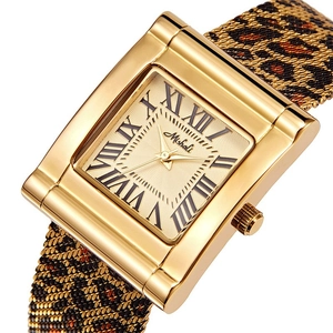 Detail of Mishali gold rectangular watch with leopard print metal woven strap and Roman dial