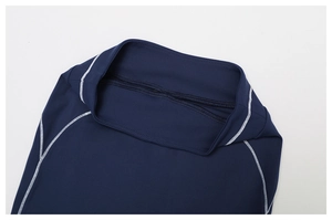 Detail of high waist yoga leggings with contrast white stitching on dark blue fabric