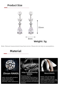 Detail of leaf-shaped zircon earrings with white pearls, size 35x8mm, weighing 5g