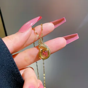 Detailed view of titanium wing pendant with gradient gemstone and crystal accents