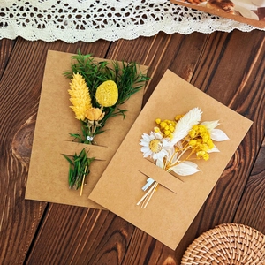 Preserved dried flower greeting cards on rustic wood background with lace detail