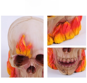 Detail showing hand-painted flame patterns and resin texture on the skull ornament