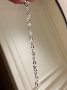 Close-up of elegant silver bracelet featuring oval links and brilliant cubic zirconia stones