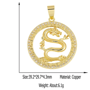 Detailed view of a golden brass dragon pendant with cubic zirconia and greek key border