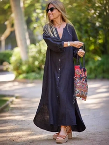 Elegant black cotton linen long-sleeve shirt dress for women in a natural outdoor garden