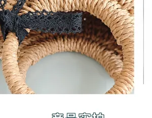 Close-up of woven straw handbag with intricate black lace bow and spiral texture