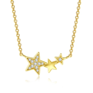 Macro detail of gold star necklace with zircon pavé and polished metal pendant