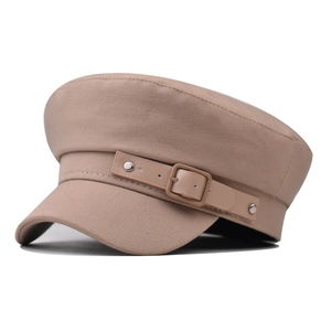 Detailed shot of khaki cotton baker boy hat featuring textured twill fabric and leather strap