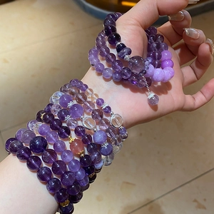 Macro detail of multi-layered natural amethyst bead bracelet with silver spacers on wrist