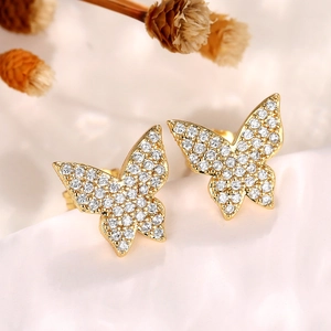 Close-up of gold-plated butterfly earrings with shimmering micro-paved cubic zirconia