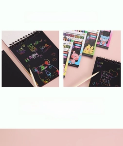 Detail of DIY scratch art notebook showing colorful tiger pattern and wooden stylus pen