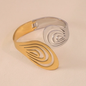 Abstract hollow cuff bracelet in two-tone gold and silver polished stainless steel