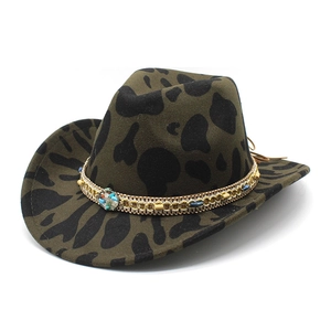 Deep green cow print wool cowboy hat with turquoise ethnic beaded band on white background