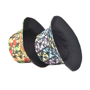 Reversible bucket hat featuring cartoon cat and maple leaf prints for outdoor sun protection