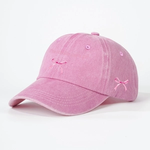 Pink washed cotton baseball cap with embroidered bows and I am literally just a girl text