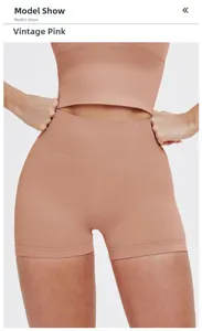 Macro shot of high-waist retro pink seamless yoga shorts showing ribbed waistband texture