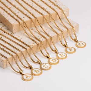 Golden stainless steel round shell initial necklaces A-G with box chains on stone steps