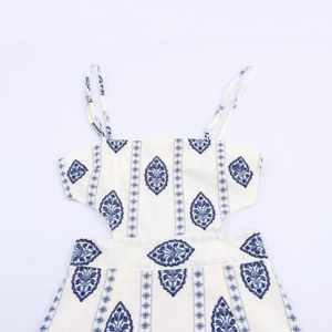 White sundress with blue ethnic embroidery and waist cut-out detail for summer