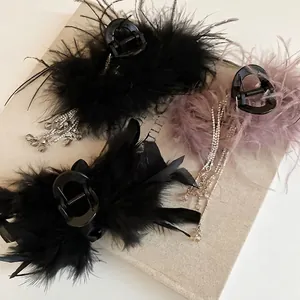 Elegant acrylic hair claw clip with fluffy feathers and sparkling rhinestone tassels