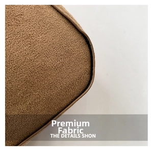 Close-up of brown faux suede texture and dark leather piping on stylish commuter bag