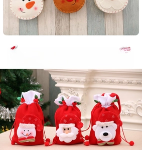 Close-up of red Christmas drawstring gift bags featuring snowman and Santa applique
