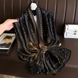 Elegant black silk scarf with golden peacock feather print and chic polka dot patterns