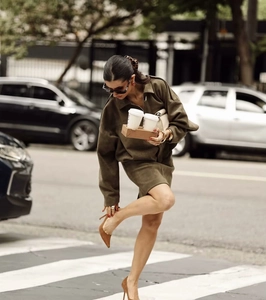 Detailed view of an olive green midi skirt set with suede texture for elegant commute