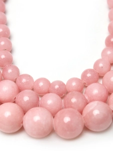 Vue macro de perles rondes en pierre rose pour la création de bijoux et bracelets