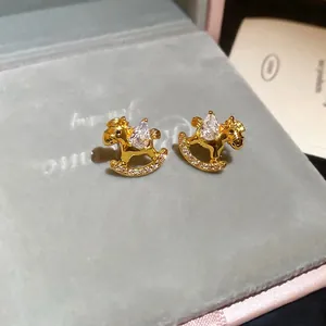 Elegant gold-plated rocking horse stud earrings featuring sparkling waterdrop zircon stones