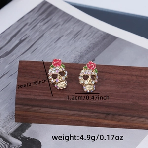 Detail of skull earrings with red rose and colorful rhinestones showing 2cm height scale