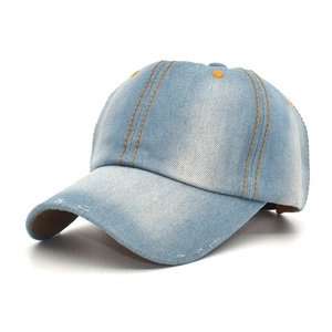 Detail of distressed light blue denim baseball cap with orange contrast stitching and frayed brim