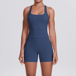 Detail of high-waist stretch yoga shorts and racerback tank top in dark blue matte fabric