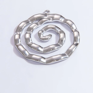 Macro shot of silver spiral metal pendant with polished finish for DIY jewelry crafting