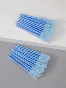 Macro detail of disposable light blue eyelash brushes with spiral synthetic fiber bristles