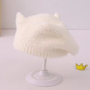 Gros plan du bonnet en peluche blanc avec oreilles de chat et texture fausse fourrure