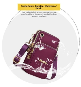 Detail of purple waterproof nylon crossbody bag with gold flower zipper and headphone jack