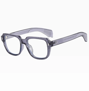 Detail shot of transparent grey square sunglasses frame with metallic rivet accents