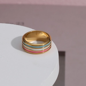 Detail of 18K gold plated ring featuring colorful blue, white, and pink enamel stripes